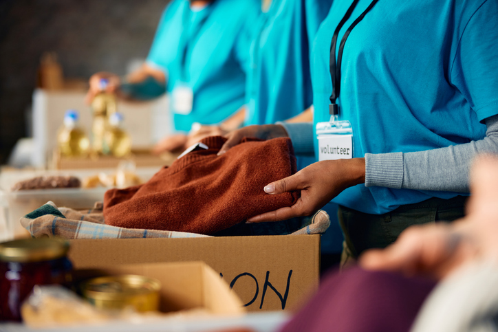image of volunteers holding clothes